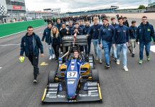 The 40 year old (Formula Student) virgin MoRe Modena Racing team members walking behind their car on the pit straight of Silverstone circuit